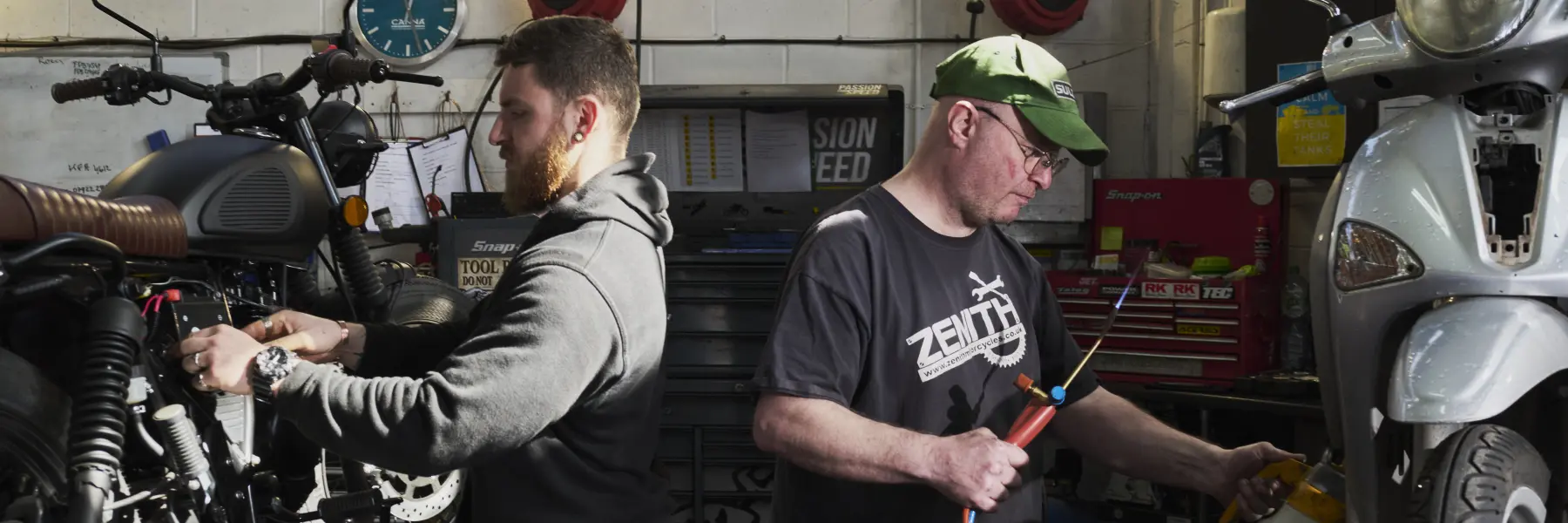Zenith Motorcycle Mechanics Working Side-By-Side